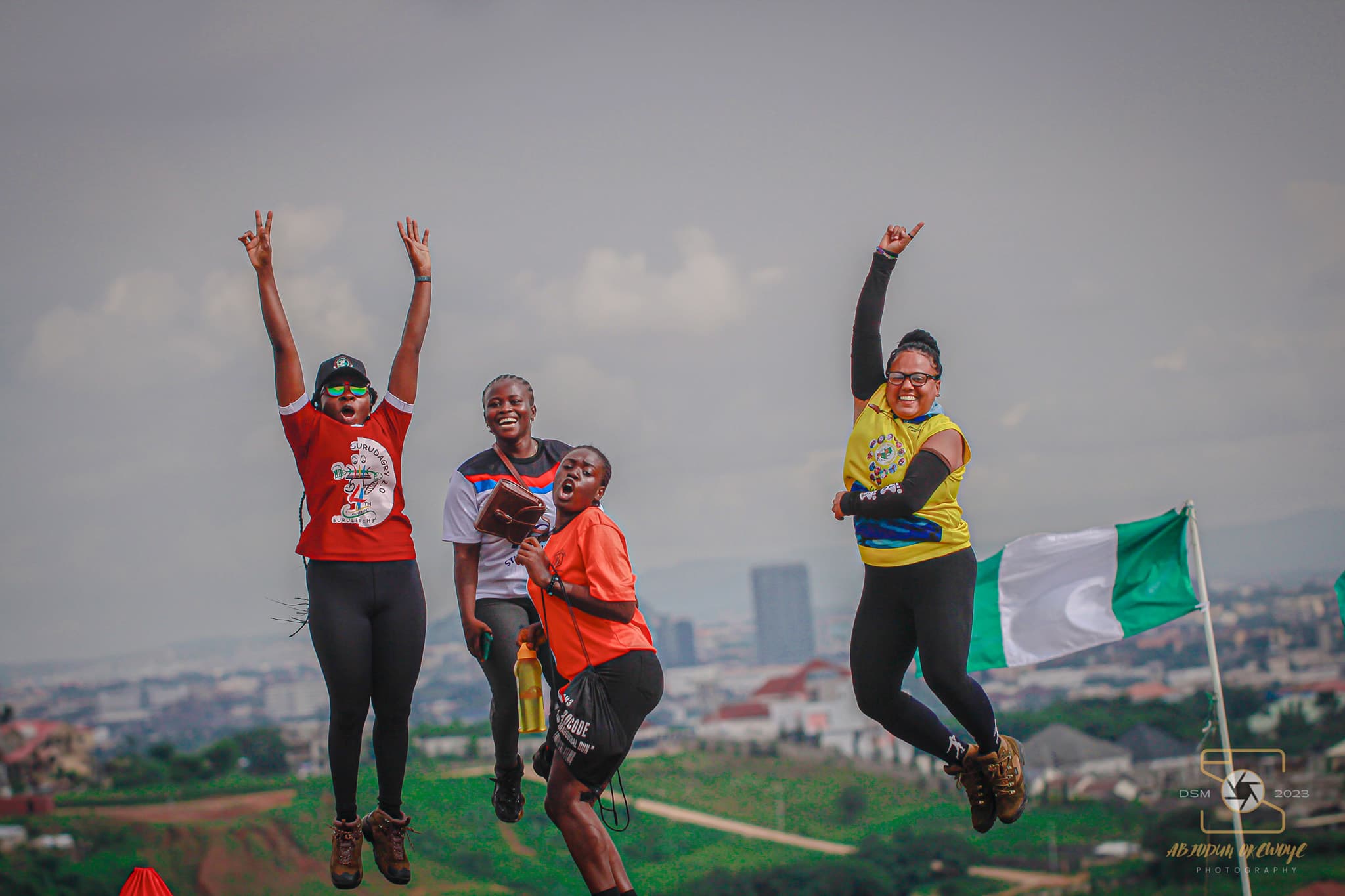 Hashers celebrating at the end of a trail above Abuja